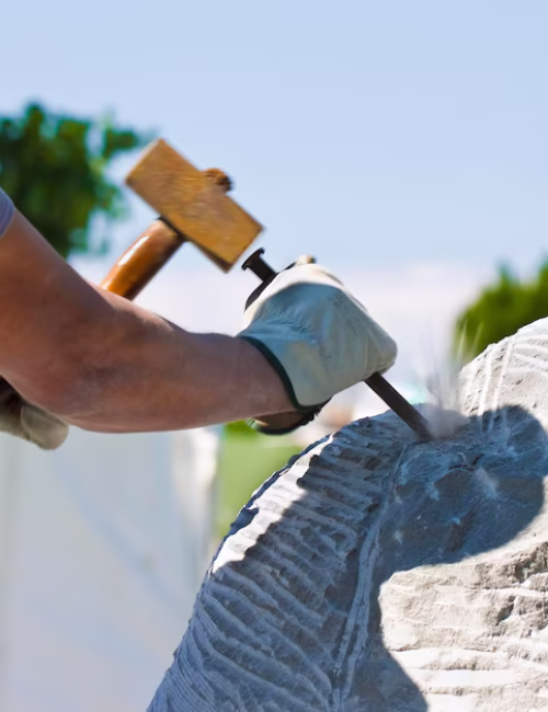 close-up-man-carving-rock-against-clear-sky_1048944-2813021
